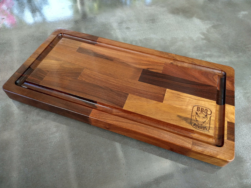 Wooden cutting board with a logo on a gray surface